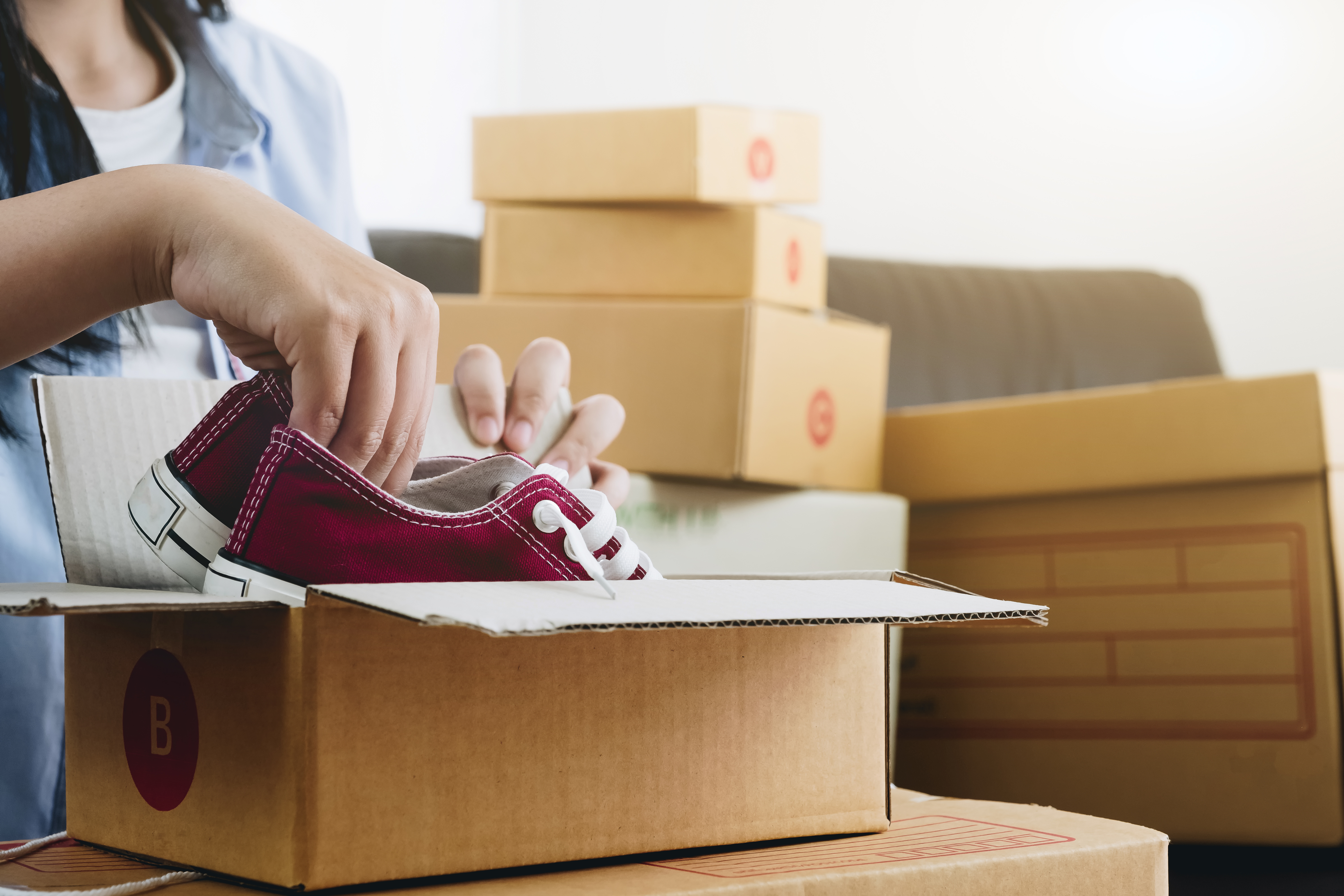 Happy young businessman owner packing shoes to cardboard box, Young Owner Woman Start up for Business Online. People with online shopping SME entrepreneur or freelance working concept.